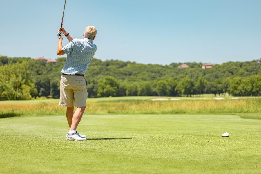 an old man playing golf showing the concept of golf instruction for seniors